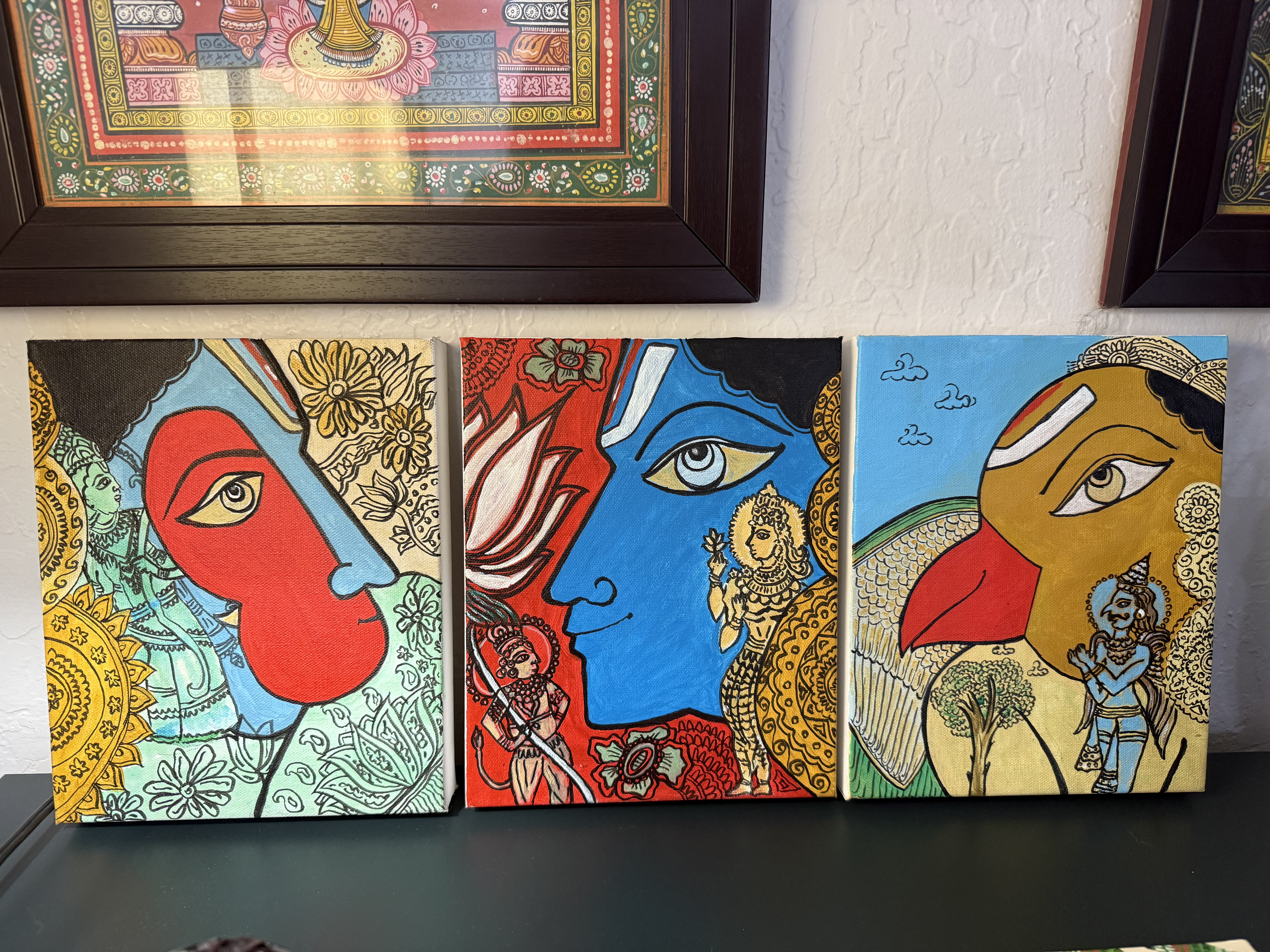 Three smaller Telangana paintings on a shelf